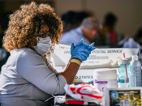 FILE PHOTO: FILE PHOTO: Fulton County election worker Ruby Freeman processes ballots in Atlanta, Georgia, U.S., on November 4, 2020.