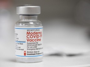 FILE - A vial of the Moderna COVID-19 vaccine is displayed on a counter at a pharmacy.