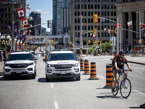 Security screening to access Parliament Hill was removed Sunday but a heavy police presence was still visible in the downtown area.