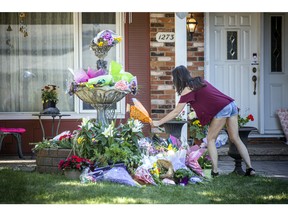 A flower memorial has been set up in the front yard of the home on Anoka Street where Anne-Marie Ready, 50, and her daughter Jasmine Ready, 15, were killed in a stabbing attack last week.