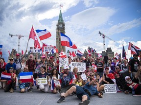 A group of participants in Saturday's protest gather together on Wellington Street in front of Centre Block on Parliament Hill.