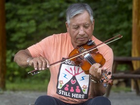 After returning from St. Mary’s indian Residential School in Kenora, Eddie Pezindewatch Côté wrote ‘Residential School Survivors Song’ on fiddle.