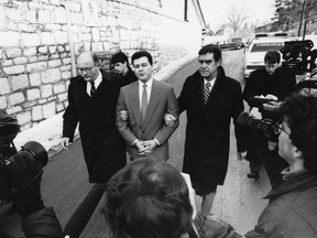 Claude Bourguignon is escorted to court in Barrie, Ont. on Feb. 4, 1991. He was eventually found guilty of the murder of his 2-1/2-year-old nephew, Paul Bourguignon Jr., whose body was found on June 2, 1989 in a dumpster near his Ottawa home.
