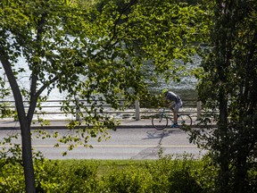 File photo/ A cyclist bikes along the Rideau Canal.