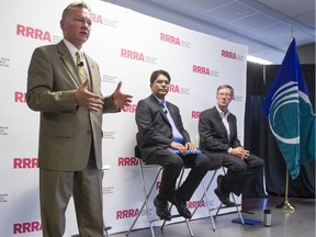 File photo: Tuesday September 23, 2014. Mayoral candidate Mike Maguire, left, speaks during an all-candidates mayoral debate at the Carleton University Residence Commons while candidates Anwar Syed, center, and incumbent Jim Watson, right, look on. Darren Brown/Postmedia