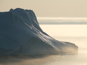 Files: A massive iceberg stands at the mouth of the Ilulissat Icefjord during a week of unseasonably warm weather on August 3, 2019 near Ilulissat, Greenland.