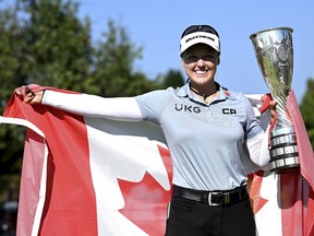 EVIAN-LES-BAINS, FRANCE - JULY 24: Brooke Henderson of Canada lifts the trophy after winning the The Amundi Evian Championship during day four of The Amundi Evian Championship at Evian Resort Golf Club on July 24, 2022 in Evian-les-Bains, France.