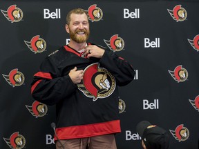Newest Ottawa Senator Claude Giroux puts on the team jersey, as his 3-year-old son Gavin watches, at the Canadian Tire Centre. July 13,2022.