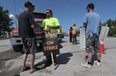 Construction workers from LiUNA Local 527 walk the picket line at Moodie Drive in Ottawa on Tuesday before the announcement that a tentative agreement had been reached.