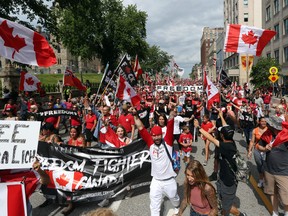 Hundreds of "Freedom Convoy" supporters march in downtown Ottawa on Canada Day July 1, 2022.