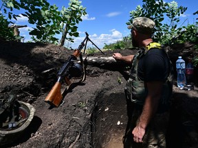 A Ukrainian soldier is pictured in a trench near the front line in eastern Ukraine on July 13, 2022, amid the Russian invasion of Ukraine.