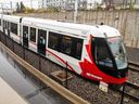 Files: A train enters the Lees Station on the O-Train Confederation Line.