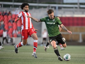 Atletico Ottawa and visiting Cavalry FC battle it out for first place overall in the CPL on July 9, 2022. The teams played to a fitting 1-1 draw.