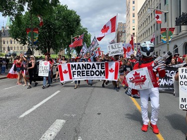 Marchers proceed along Wellington Street near Parliament Hill on Canada Day.