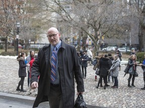 Richard Elliott makes his way into a Toronto court, on Monday, Nov. 9, 2019. Canadian HIV and AIDS organizations say the start of an international AIDS conference in Montreal this week is shining a light on Canada's lagging response to the disease. Elliott, a former executive director of the HIV Legal Network, a Toronto-based advocacy organization, says that not only has funding been frozen but money is increasingly being used to fight other sexually transmitted diseases.