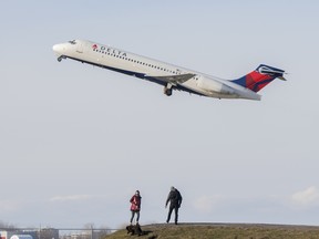 File photo: A Delta Air Lines plane takes off from Montreal Trudeau Airport in Montreal, Sunday, December 5, 2021.THE CANADIAN PRESS/Graham Hughes
