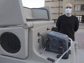 A file photo shows Robert Delatolla standing beside a pumping station used to collect wastewater samples that are screened for COVID-19 subvariants.