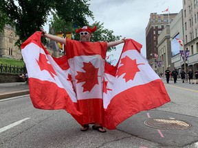 Andrew larche patrols wellington street in a custom canadian flag robe.