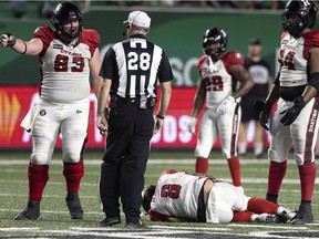 Redblacks quarterback Jeremiah Masoli lays on the turf after being injured by a low hit from the Roughriders' Garrett Marino in the fourth quarter of Friday's game in Regina.
