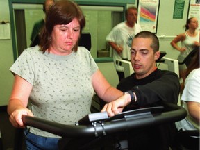 Ottawa Sun page sixer Sue Sherring gets a little help from her personal trainner Chad Beaulieu at the Neapean Sportsplex.