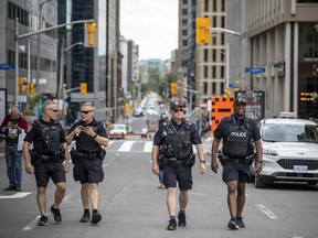 Se sentía como un día soleado normal de fin de semana en el centro de la ciudad de Ottawa, pero con una presencia policial mucho más alta, incluidos estos oficiales que patrullaban a pie en Metcalfe Street, al sur de Parliament Hill.