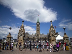 Lines formed as people waited to pass through the security checks for access to Parliament Hill on Saturday afternoon.