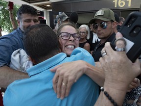 'Freedom Convoy' organizer Tamara Lich is hugged by supporters as she leaves the courthouse after being released from jail on Tuesday, July 26, 2022 in Ottawa.