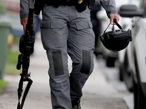 File photo/ An Ottawa police officer holds an ARWEN (Anti Riot Weapon Enfield).