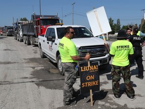 Construction workers from LiUNA Local 527 and 527a walk the picket line at Lafarge on Moodie Drive in Ottawa earlier this month.