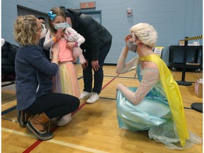 File photo: 27 January 2022. Nora Burroughs (6) and her mother Angela were happy to see Guylaine Chartier, dressed as Elsa, as she was vaccinated on Thursday.  Ottawa Public Health staff dressed as superheroes to help children as they put a needle in them.