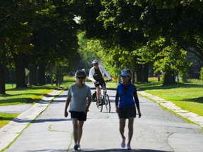 People make their way along Morningside Lane in Ottawa on Wednesday, July 13, 2022.&ampnbsp;Environment Canada has issued heat warnings for most of Ontario.