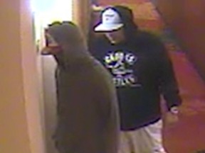 Photo of two suspects in 2018 beating the death of Mohamad Mana.  Man #2: Black male, medium build, wearing a dark hoodie, dark pants, and a two-tone baseball cap.  Male #3: White/Middle Eastern male, medium to heavy build, wearing a dark Crooks and Castles hoodie, light-colored capri pants, and two-tone high-top sneakers.