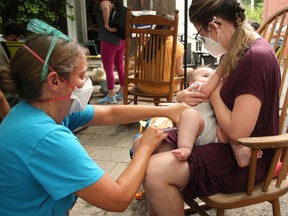 Doctor administers COVID-19 vaccine to a baby.