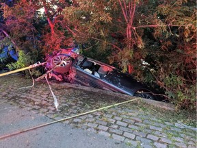 Ottawa Fire Services crew members extricated a driver from a vehicle involved in a single-vehicle crash near the Rideau River at the intersection of Bank Street and Riverside Drive in Ottawa on Friday, July 22, 2022.