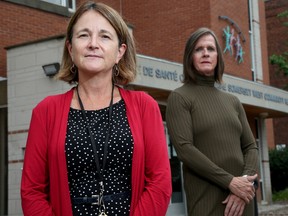 Dawn Lyons (left), director of family and community health and harm reduction at the Somerset West Community Health Centre, along with Brook Lynn Davies, a harm reduction worker and team lead in the respite centres, stand outside the CHC in the Chinatown area of Ottawa.