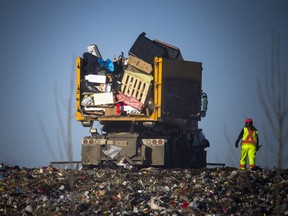 A garbage truck unloads trash at Ottawa's Trail Road landfill