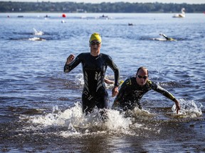 The Riverkeeper Open Water Swim race took place in the Ottawa River, starting and finishing at the Lac Deschênes Sailing Club, Sunday, August 14, 2022. Klara Doelle (left) and Bruce McNicoll race to the finish line of the 4K race Sunday morning.