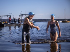 The Riverkeeper Open Water Swim race took place in the Ottawa River, starting and finishing at the Lac Deschênes Sailing Club, Sunday, August 14, 2022. Robert Landriault and Charlotte Anderson congratulate each other as the finish the last stretch of the 1.5K race Sunday morning.