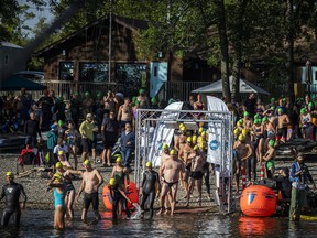 The Riverkeeper Open Water Swim race took place in the Ottawa River, starting and finishing at the Lac Deschênes Sailing Club, Sunday, August 14, 2022. The first heat of the 4K swimmers walked out to the start line in the water.