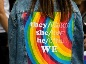 A person sports a gender-neutral pronoun jacket. A new poll suggests only 15 per cent of those asked add gender pronouns to their online communications.