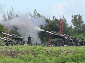 Taiwan military soldiers fire the 155-inch howitzers during a live fire anti landing drill in the Pingtung county, southern Taiwan on August 9, 2022.