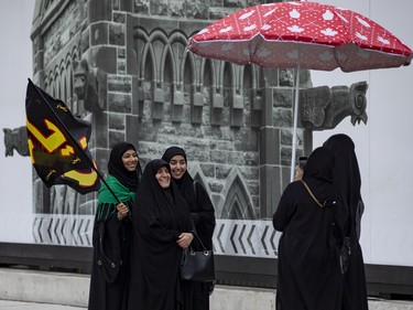 Women have their photo taken on Parliament Hill prior to a commemoration of the martyrdom of Imam Hussain, grandson of the Islamic prophet Mohammad, on Monday, Aug. 8, 2022.