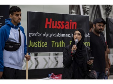 Berak Hussain, a Muslim counsellor at Carleton University and community leader, speaks in a heavy downpour on Parliament Hill during a commemoration of the martyrdom of Imam Hussain, grandson of the Islamic prophet Mohammad, on Monday, Aug. 8, 2022.