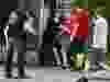 OTTAWA — Samuel Rizzotto (all black) is put in a headlock by TUPOC director William Komer near the former St. Brigid’s Church on Thursday, Aug. 25, 2022 — . ERROL MCGIHON, Postmedia