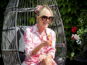 Katie Hession, a digital creator and social media influencer, sat amongst the stunning vines and flowers at Tavern at the Gallery during the launch of the Ottawa Garden Festival, which runs until Aug. 21.