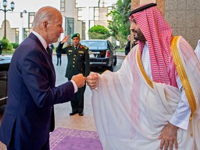 A handout picture released by the Saudi Royal Palace on July 15, 2022, shows Saudi Crown Prince Mohammed bin Salman (R) bumping fists with U.S. President Joe Biden at Al-Salam Palace in the Red Sea port of Jeddah.