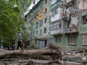 Local residents look at the damage after an early morning Russian forces strike in Kostiantynivka, eastern Ukraine, amid the Russian invasion of Ukraine.