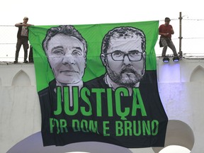 (FILES) In this file photo taken on June 26, 2022, people attend a demonstration in Rio de Janeiro, Brazil, to call for justice for the murder of Brazilian indigenous expert Bruno Pereira and the British journalist Dom Phillips, who were murdered while on a reporting mission in the Amazon rainforest. - Police in Brazil said they arrested five new suspects on Saturday August 6, 2022, in the murder of a British journalist and Brazilian indigenous expert in the Amazon rainforest, all allegedly involved in an illegal fishing ring.