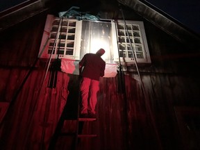 Bat expert Derek Morningstar checks a trap he set up outside a maternity roost of up to 200 Little brown bats at MacSkimming Outdoor Education Centre. No fools, the bats evaded the trap as they left for their night of hunting. Morningstar suspects they used another exit.