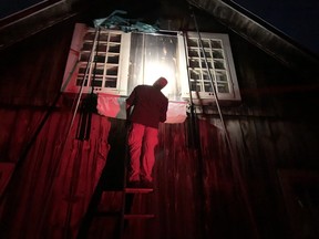 Bat expert Derek Morningstar checks out a trap he set up outside a maternity roost for up to 200 little brown bats at the MacSkimming Outdoor Education Center.  No fools, the bats evaded the trap when they left for their night of hunting.  Morningstar suspects they used another exit.